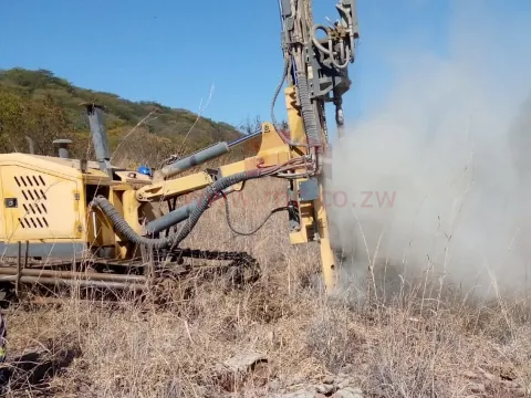 crawler rig drilling blast hole